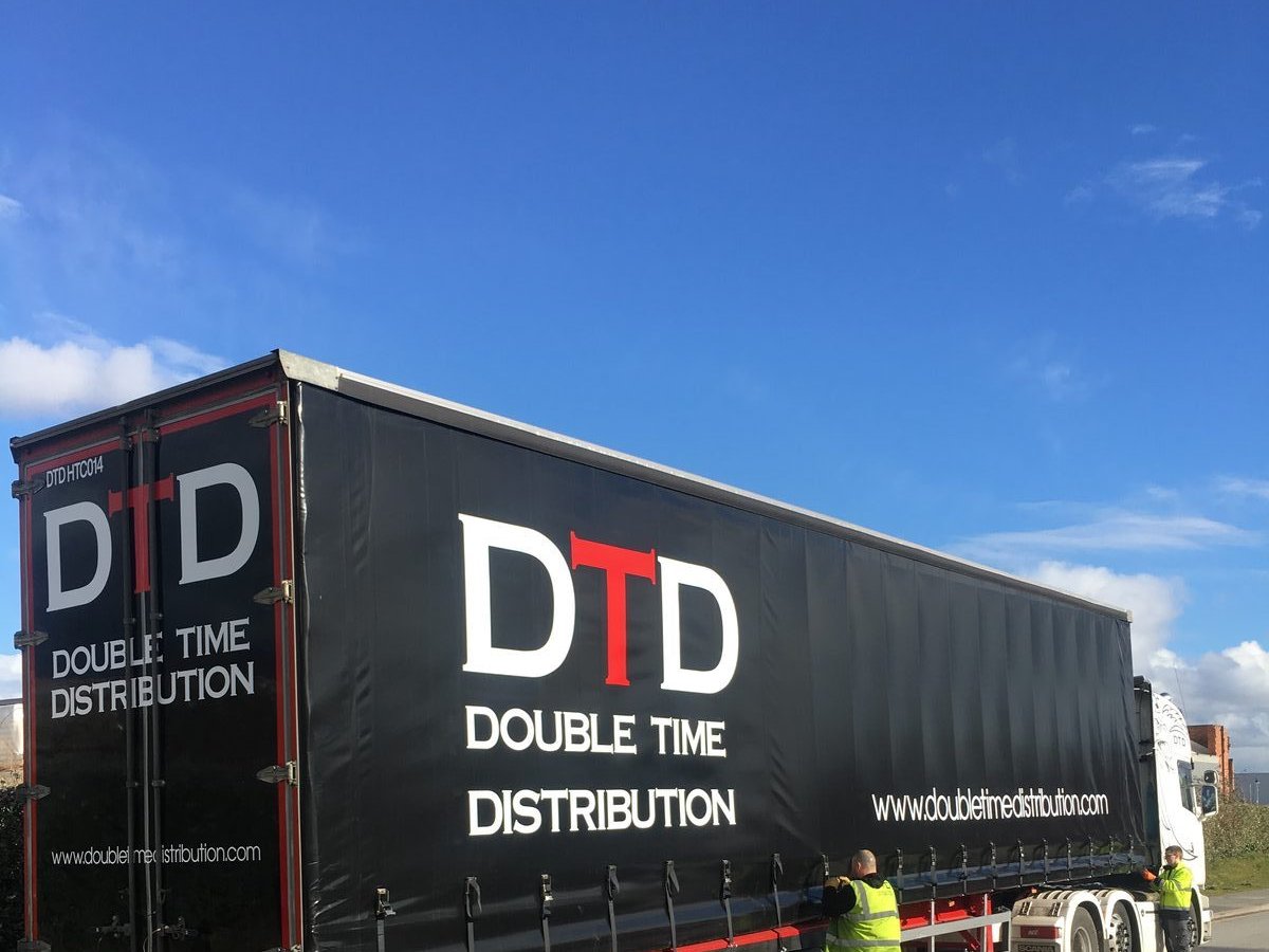 Double Time Distribution team preparing a trailer for the road