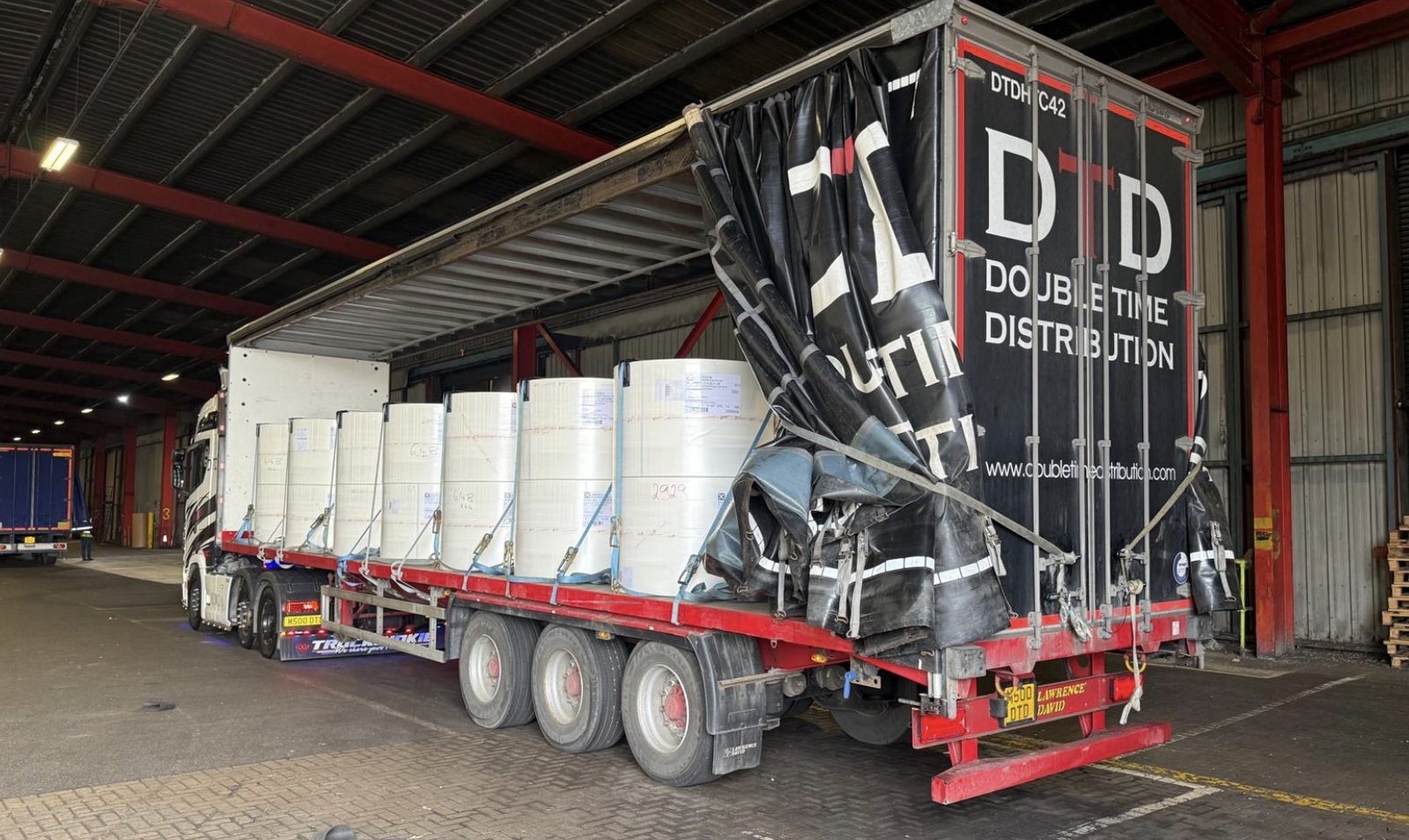 Double Time Distribution artic loading paper rolls at a manufacturing warehouse