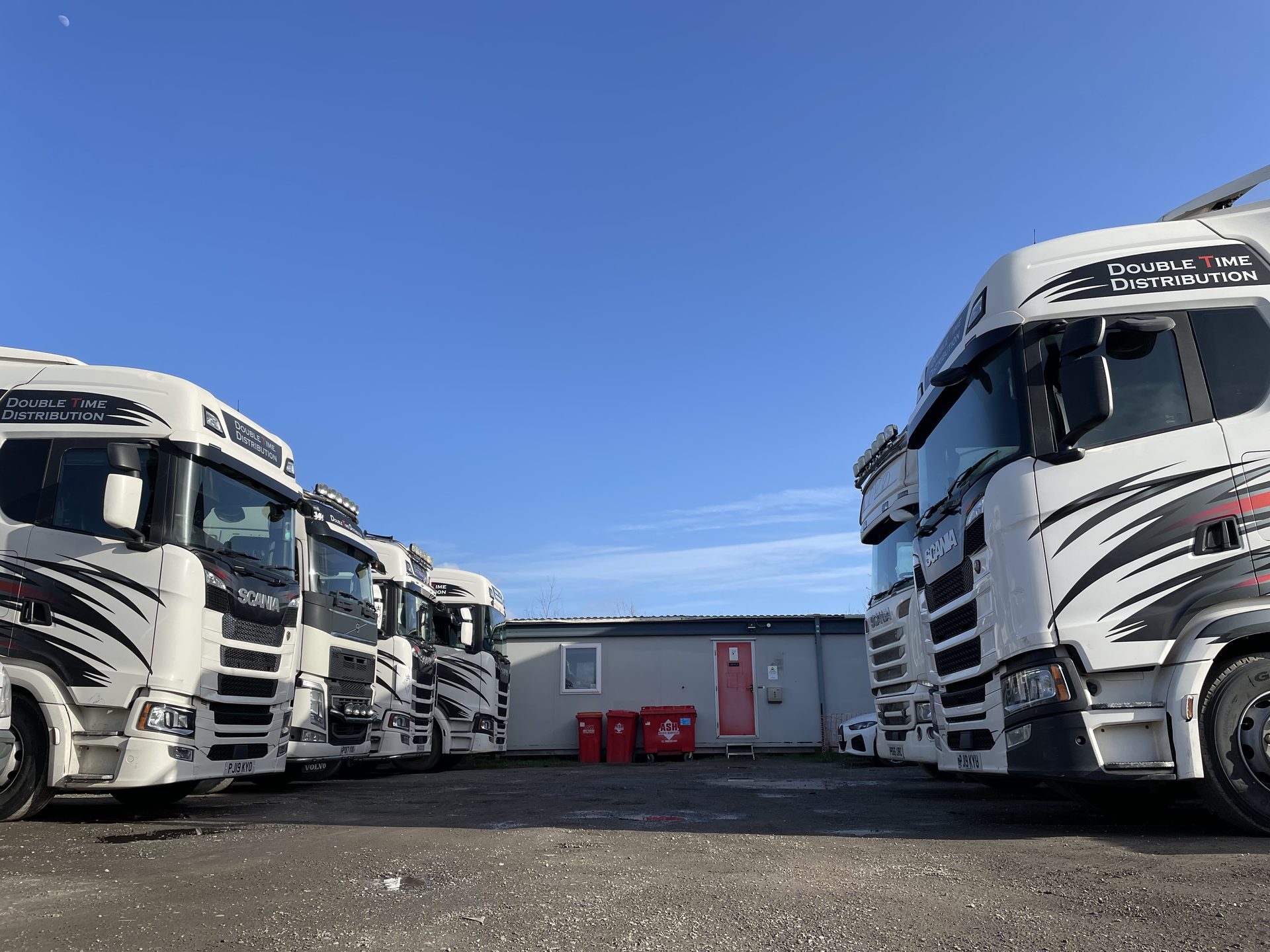 Double Time Distribution curtainsider artic fleet lined up at the Holywell depot